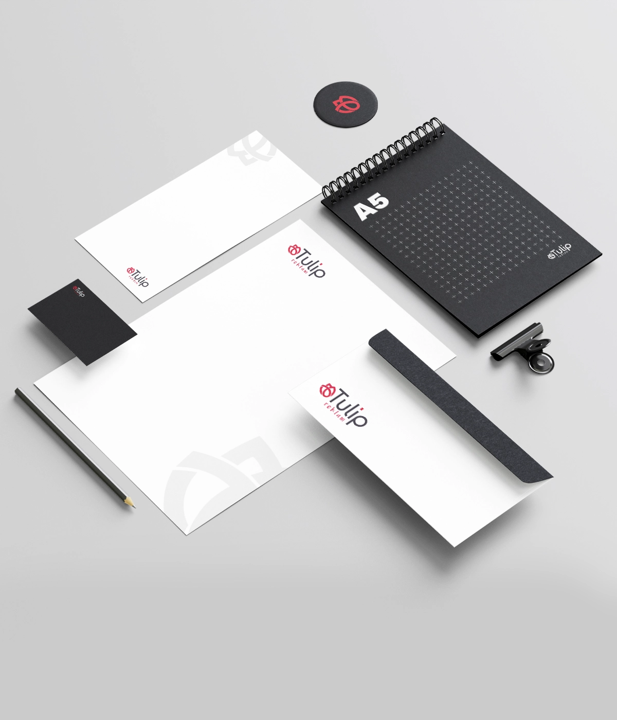 Minimalist corporate stationery identity kit mockup with a branded letterhead, envelope, and notebook.